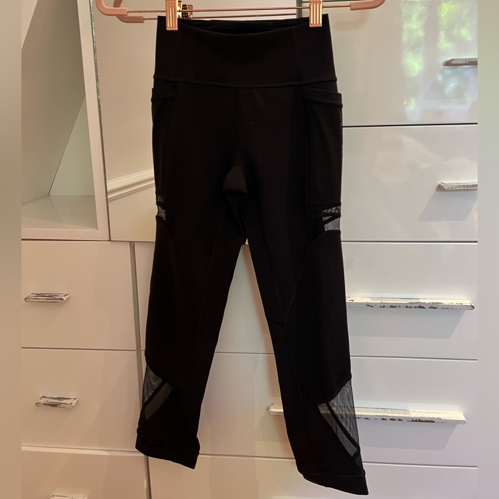 3/4 length black Lululemon leggings with pockets and mesh panels